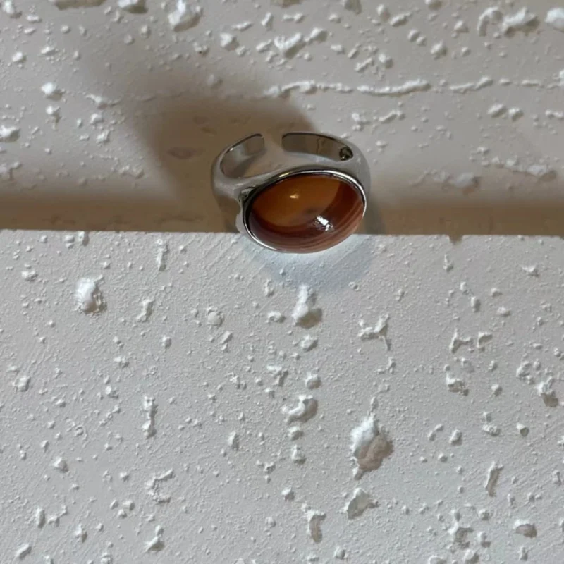 Honey jade stone alloy open ring displayed on a white base.
