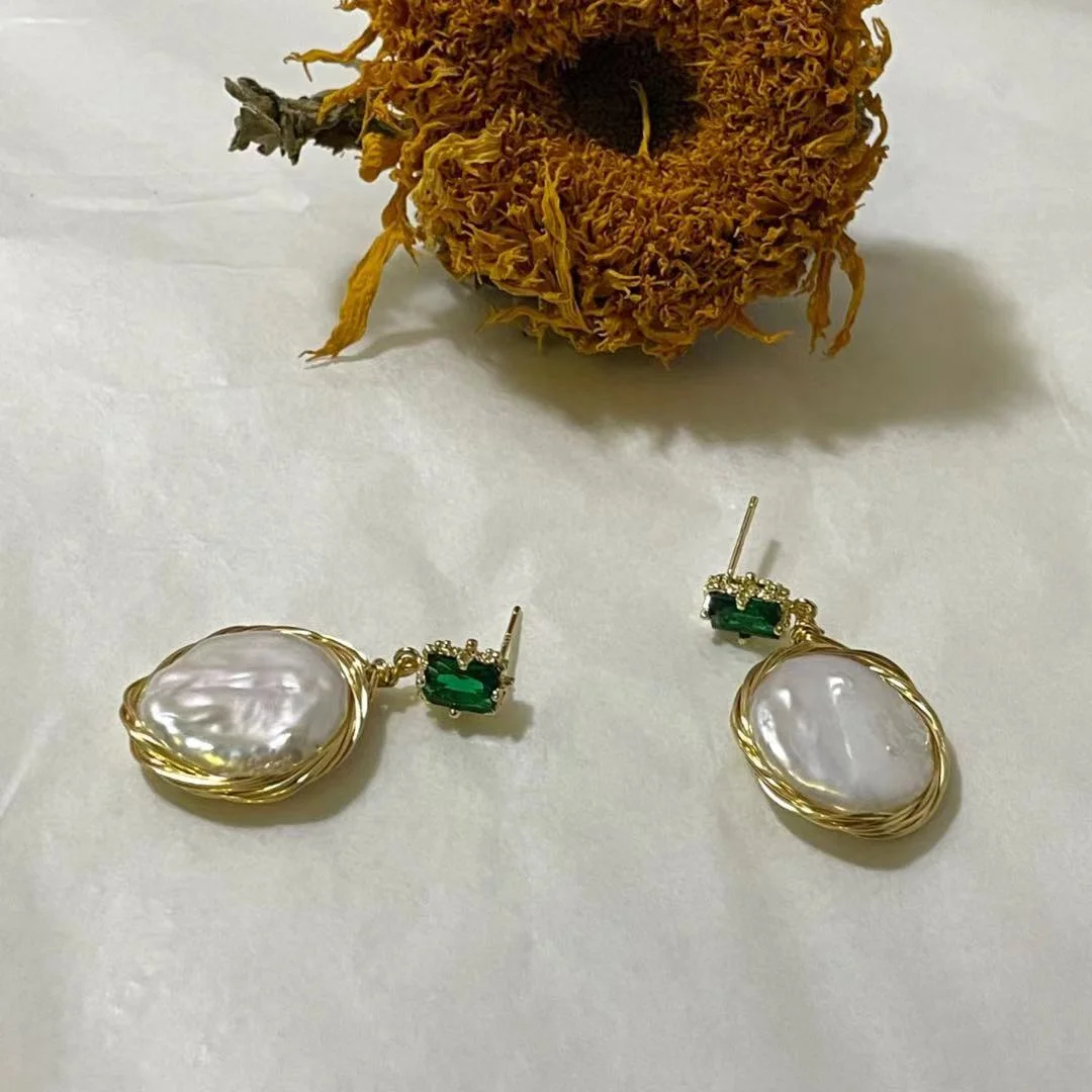 18K Gold Plated Freshwater Pearl Baroque Drop Earrings with a dry sunflower in the background.