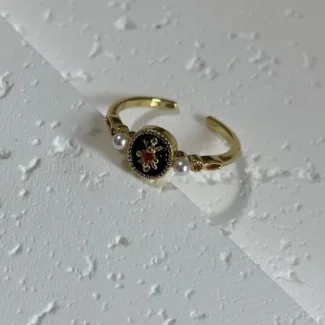 14K Vintage Black Iris Enamel Open Ring tilted on white base