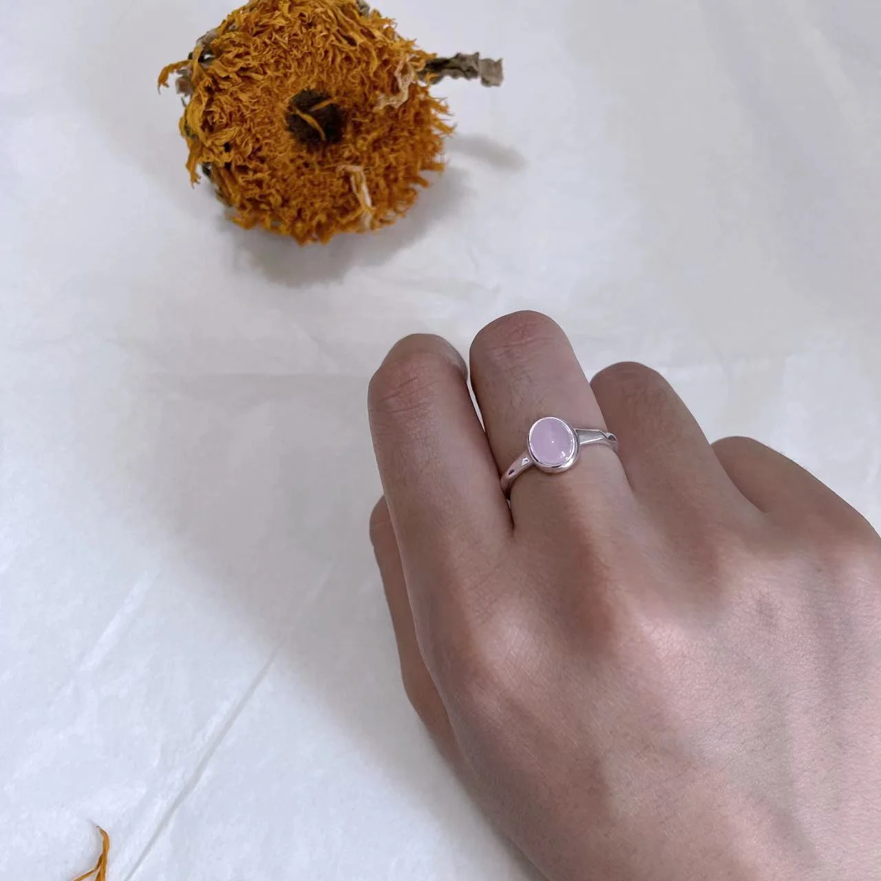 Strawberry Quartz Silver-Plated Open Ring worn on hand with sunflower above