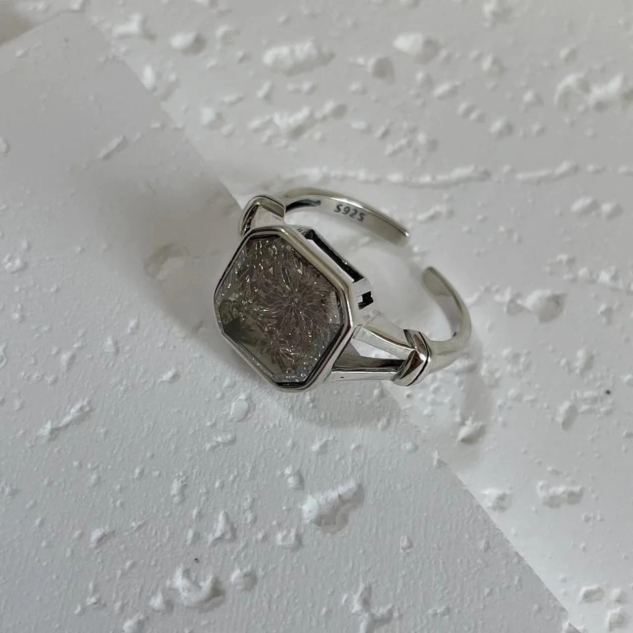 925 Sterling Silver White Topaz Ring tilted on white base