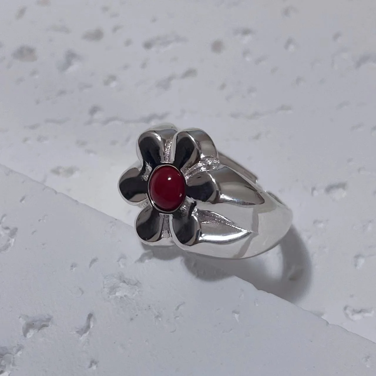 925 Sterling Silver Floral Ring with Red Natural Stone, Angled on White Plaster Board